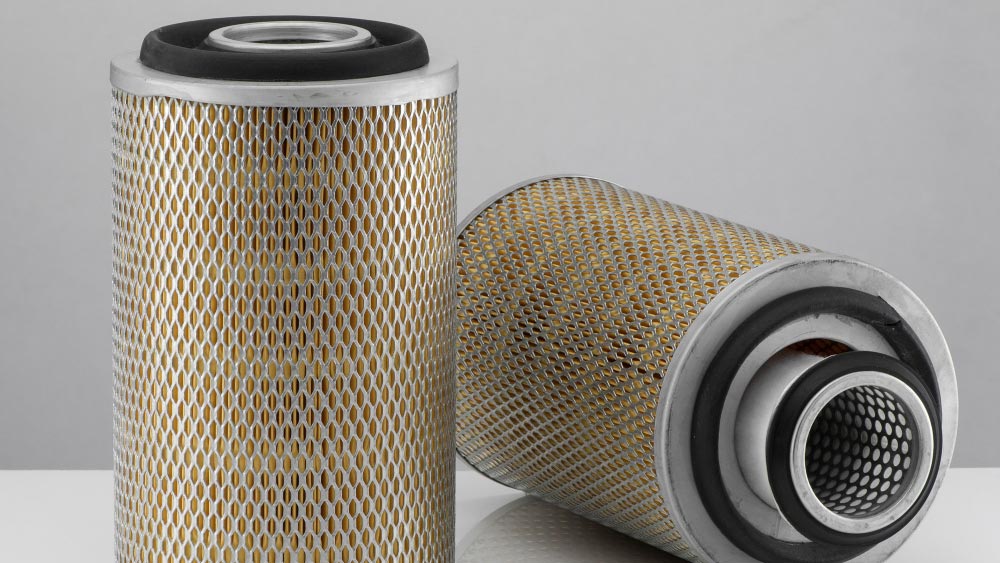 Two cylindrical grow tent carbon filters with gold mesh design and black end caps, essential for air purification.